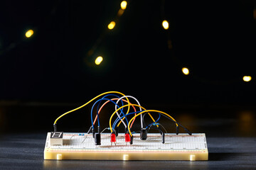 Breadboard electrical for learn for beginners on a dark background.