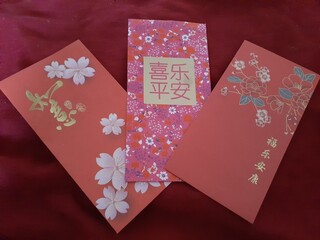 three chinese new year greetings, each with an animal and a chinese letter in