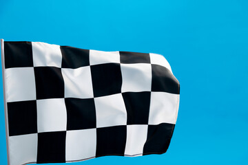 Checkered flag waving on blue background