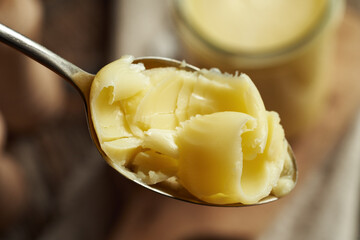 Ghee or clarified butter on a spoon, closeup