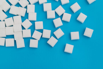 Fototapeta na wymiar Sugar cubes on blue background