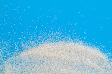 White sugar crystals on blue background
