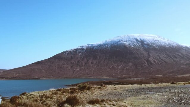 Car point of view, POV driving along a landscape and scenery through beautiful roads in the Scottish highland.