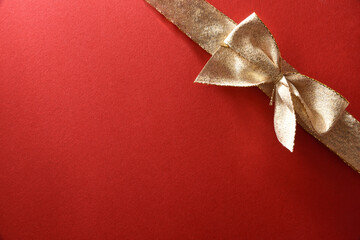 Gift wrap background with gold bow on red paper
