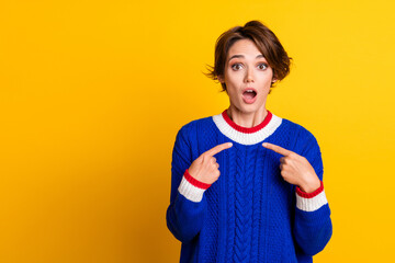 Photo portrait of lovely young lady point self frightened confused wear trendy blue knitwear garment isolated on yellow color background