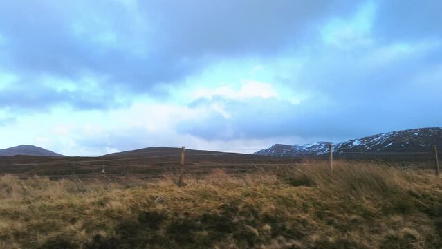 Car point of view, POV driving along a landscape and scenery through beautiful roads in the Scottish highland.