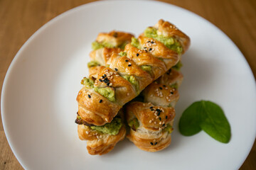 Turkish borek rolls with spinach and cheese on the white plate. A traditional Turkish pastry
