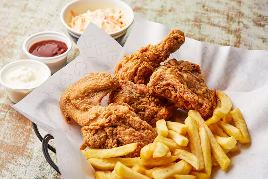chicken broasted with french fries, chili sauce and mayo dip served in dish isolated on table top view of arabic food