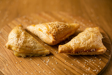 puff pastry triangles Homemade asian pastry samosa on wooden background.
