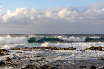 Waves rolling in over volcanic rock in Puert de las Nieves, Gran Canaria, Spain