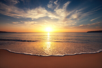 Fototapeta na wymiar Color tropical morning with clouds over sea horizon, ocean beach sunrise