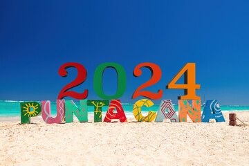 Tropical island beach Bavaro, Punta Cana, Dominican Republic and color letters caption on the sand 2024 - 725801696
