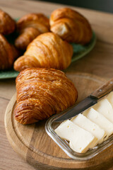 a lot of Croissant with butter on a plate