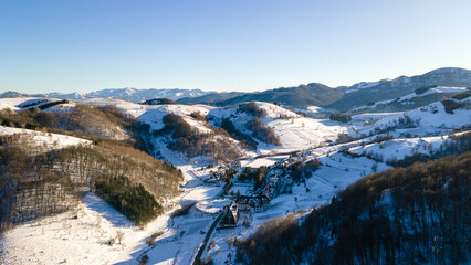 Aerial high angle view of ski resort town Brzece, Kopaonik, Serbia mountain slopes with valley in winter sunlight