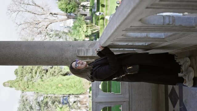 A woman explores the historical architecture of istanbul's topkapi palace, hinting at tourism and culture.