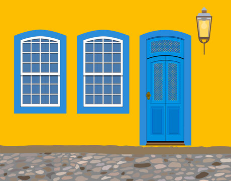 Paraty, Brazil. Facade of yellow house with blue doors and windows from the colonial period and cobblestone street in the historic center. Realistic vector illustration.