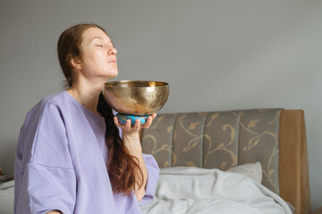 Woman Embracing Sound Healing with Singing Bowl