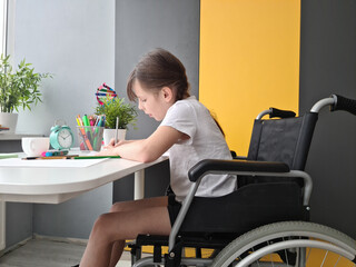 Disabled child schoolgirl with homework in class at school
