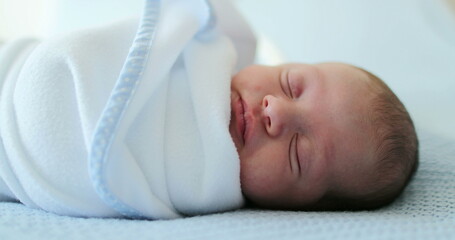 Newborn baby sleeping covered with blanket