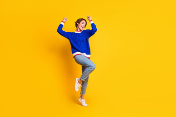 Fototapeta na wymiar Full length photo of excited lucky lady dressed knitted sweater rising fists screaming yes empty space isolated yellow color background