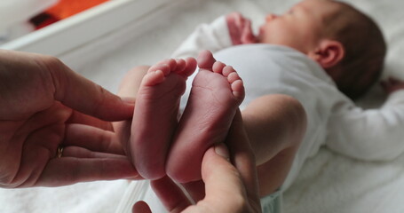 Showing newborn baby feet holding infant foot