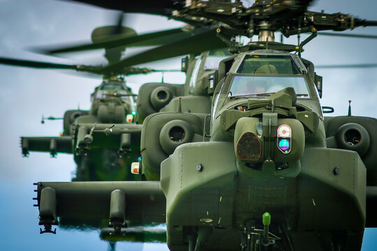A line of three WAH-64 Apache Longbow attack helicopters coming into land, RAF Shawbury, Shropshire