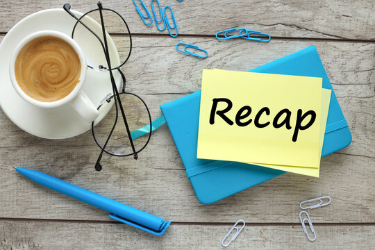 top view of a cup of coffee and glasses. blue notepad and text on paper Recap