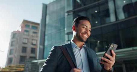 Phone, social media and wind with businessman in city, walking on street or sidewalk for morning work commute. Smile, mobile or contact with happy young employee in urban town for travel journey - Powered by Adobe
