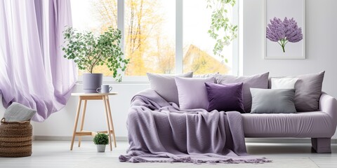 Real photo of white living room interior with a grey settee, green cushions, a purple blanket, coffee table with fruits, heather, posters on wall, and a window with white and dirty pink curtains.