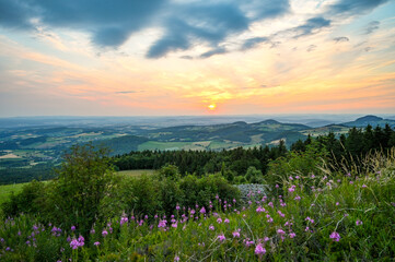 Wasserkuppe - panoramic view from the Radom observatory on the Wasserkuppe in the Hessian Rhön in summer towards Fulda in the sunset, Hessen, Germany - obrazy, fototapety, plakaty
