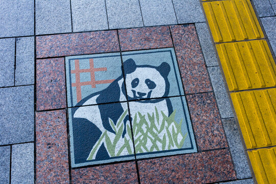 Tokyo, Japan, 26 October 2023: Artistic Panda Tile on Pedestrian Walkway.