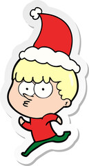 sticker cartoon of a curious boy running wearing santa hat