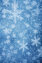 Naklejka na ściany i meble Snow flakes falling on a serene blue background. Perfect for winter-themed designs and holiday greetings