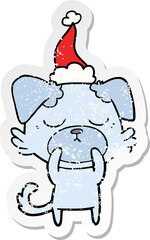cute distressed sticker cartoon of a dog wearing santa hat