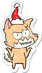 distressed sticker cartoon of a grinning fox wearing santa hat