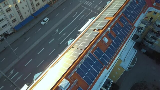 Solar photovoltaic panels mounted on roof of swedish condo building in Linkoping residential area. Renewable electricity development
