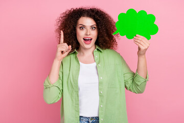 Photo portrait of pretty young girl hold comics cloud point up brilliant idea wear trendy green outfit isolated on pink color background