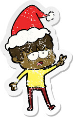 distressed sticker cartoon of a exhausted boy wearing santa hat
