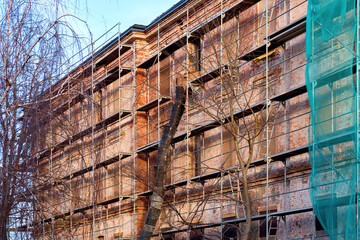 Metal scaffolding. Repair of the building facade. Major renovation of a multi-storey building.