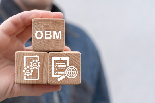 Man holding wooden cubes sees text: OBM. OBM Online Business Management Concept. Global business structure of networking. Analysis and data exchange. Business strategy, technology and social network.