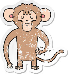 distressed sticker of a cartoon monkey scratching