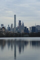 New York City skyline from Central Park Lake with reflection in the water