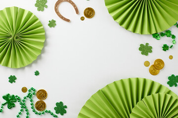 Irish bliss: St. Patrick's Day extravaganza. Top view of paper party props, trefoils, coins,...