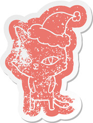 cartoon distressed sticker of a cat with bright eyes wearing santa hat