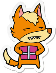sticker of a cartoon fox with present