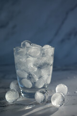 Glass of mineral carbonated water with ice cubes.