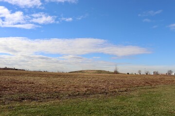 The grass field in the country on a cloudy day.