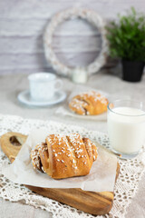Traditional finnish cinnamon and cardamon rolls, korvapuusti. Home made buns with milk for breakfast. Hight key. 