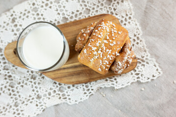 Traditional finnish cinnamon and cardamon rolls, korvapuusti. Home made buns with milk for breakfast. Hight key. 