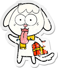 distressed sticker of a cute cartoon dog with christmas present